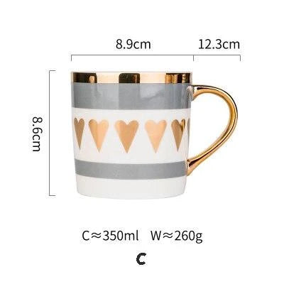 Elegant porcelain coffee mug with a lustrous gold heart design, perfect for enjoying hot beverages in style.