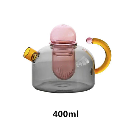 Elegant glass teapot and teacup set in vibrant contrasting colours, designed for a refined tea experience