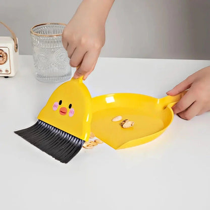 Compact table broom and dustpan set for children, featuring a yellow broom and dustpan made of durable materials for easy cleaning and tidying of small spaces.