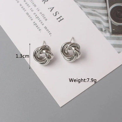 Elegant geometric statement earrings with a luxurious gold finish, featuring a unique hollow twist design.