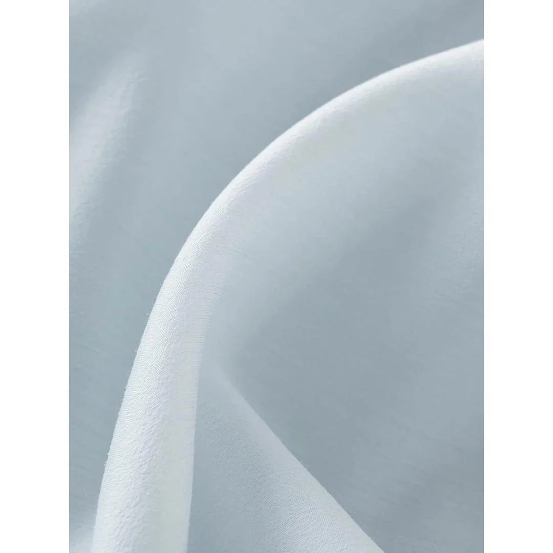 A light blue dress with a v-neck, puff sleeves, and a ribbon detail at the waist