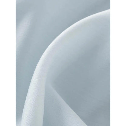 A light blue dress with a v-neck, puff sleeves, and a ribbon detail at the waist