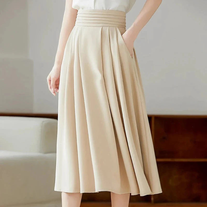 Elegant high-waisted pleated skirt with pockets in apricot colour, made from a blend of acrylic, cotton, and polyester for comfort and durability.