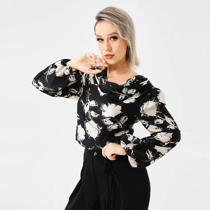 Elegant ladies' blouse with a printed pattern, dropped collar, and long sleeves in a classic white colour