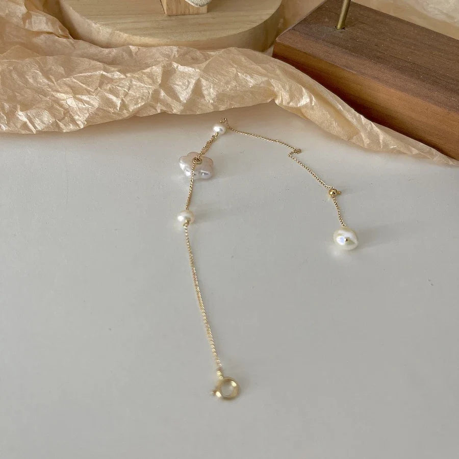 Elegant 14K gold-plated bracelet adorned with shimmering freshwater pearls, a timeless British-inspired accessory.