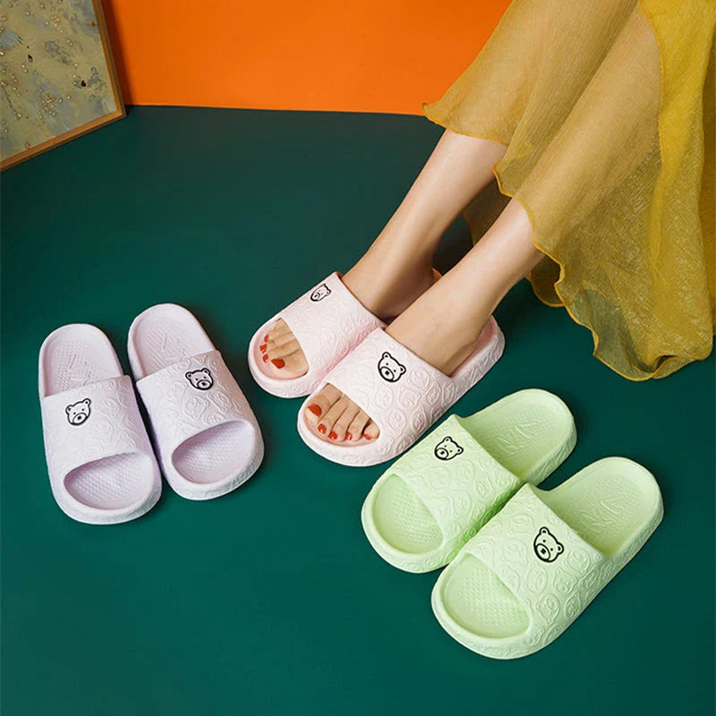 Cosy bear paw slippers in purple colour with soft, plush lining for relaxing indoor wear