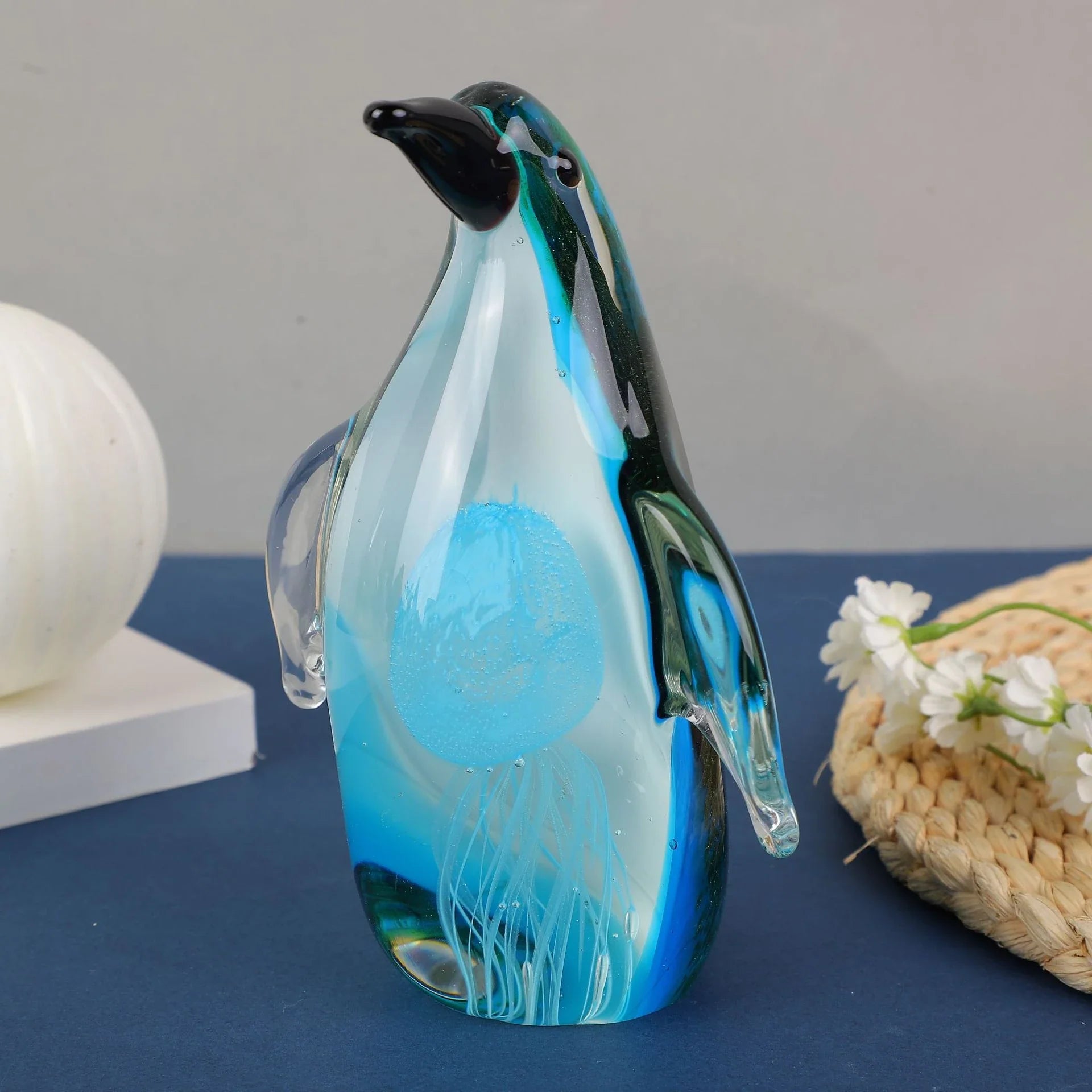 Exquisite handcrafted glass penguin ornament with a striking green-backed design, showcasing the beauty of marine life