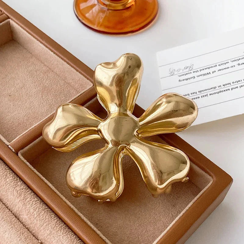 Gold floral metal hair claws - chic hair accessories for women with modern design and natural elegance