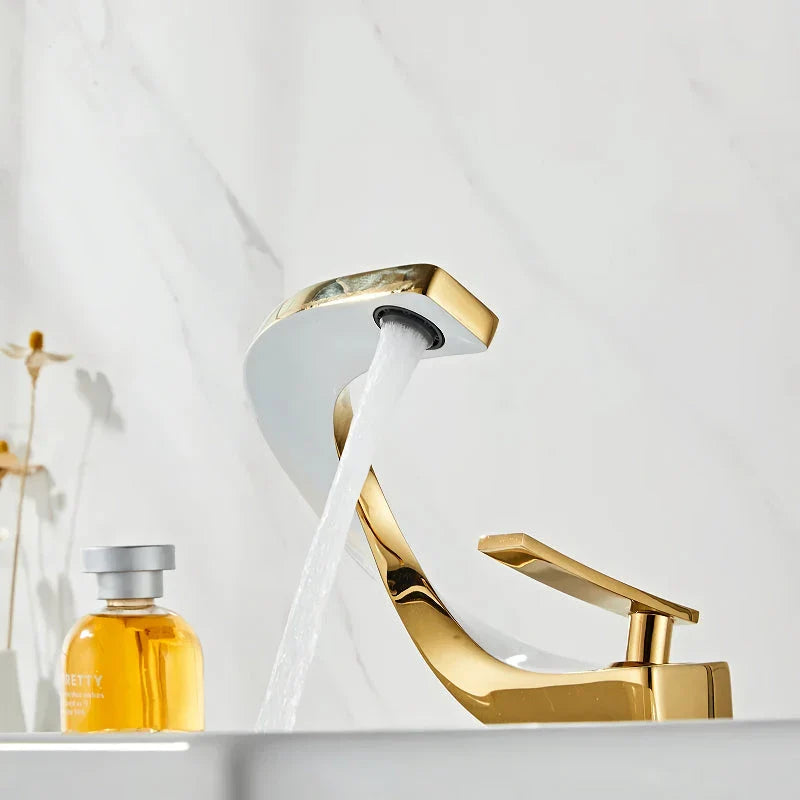Elegant brass gold and white bathroom basin faucet with sleek, contemporary design