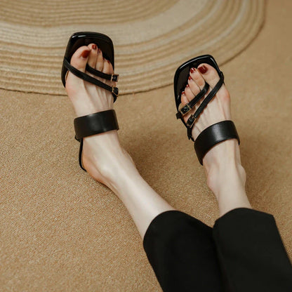 Elegant black genuine leather high heel open toe sandals with a sleek silhouette and chic buckle detail