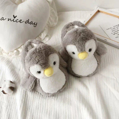 Pair of cosy, plush home slippers featuring a playful penguin design
