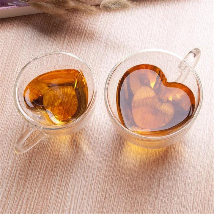 A charming heart-shaped ceramic mug with a smooth, glossy finish, perfect for enjoying hot beverages like tea or coffee.