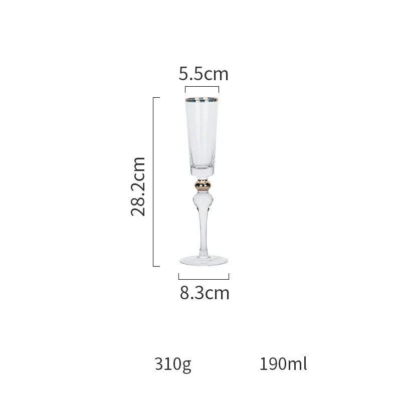 Elegant crystal wine glasses with refined gold vertical patterns, perfect for enjoying fine wines and champagne