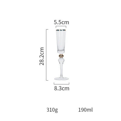 Elegant crystal wine glasses with refined gold vertical patterns, perfect for enjoying fine wines and champagne