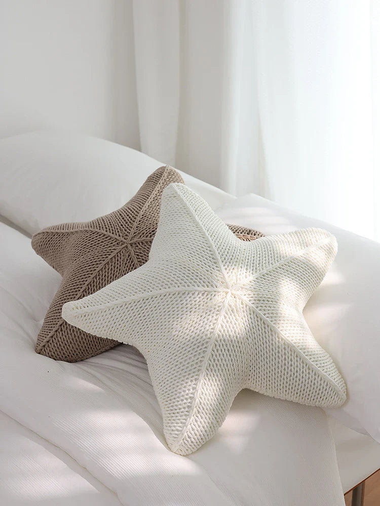 Artfully hand-knitted starfish-shaped cushion in a range of sophisticated colour options, providing plush comfort and coastal charm for any living space.
