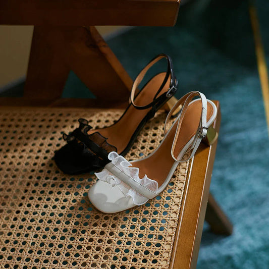 Elegant leather sandals with square toe, thin heel, and unique buckle design for high-profile events and celebrations