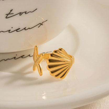 Adjustable stainless steel ring with starfish and shell accents, perfect for beach and casual wear