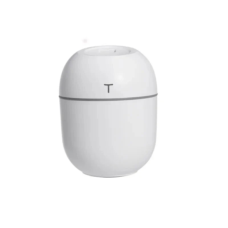 Compact ultrasonic humidifier and aroma diffuser with LED night light, designed for use in home or office spaces.