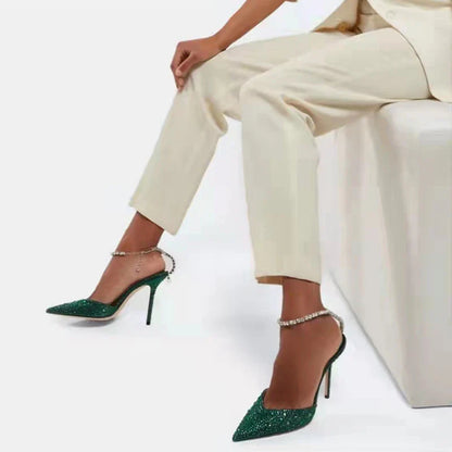 Elegant stiletto sandals with rhinestone chain embellishment, showcasing a sleek pointed toe design and matte finish for a sophisticated British-inspired look.