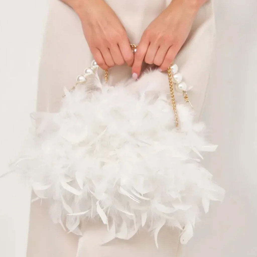 Elegant feather clutch bag with pearls and metal chains, a versatile and sophisticated evening accessory
