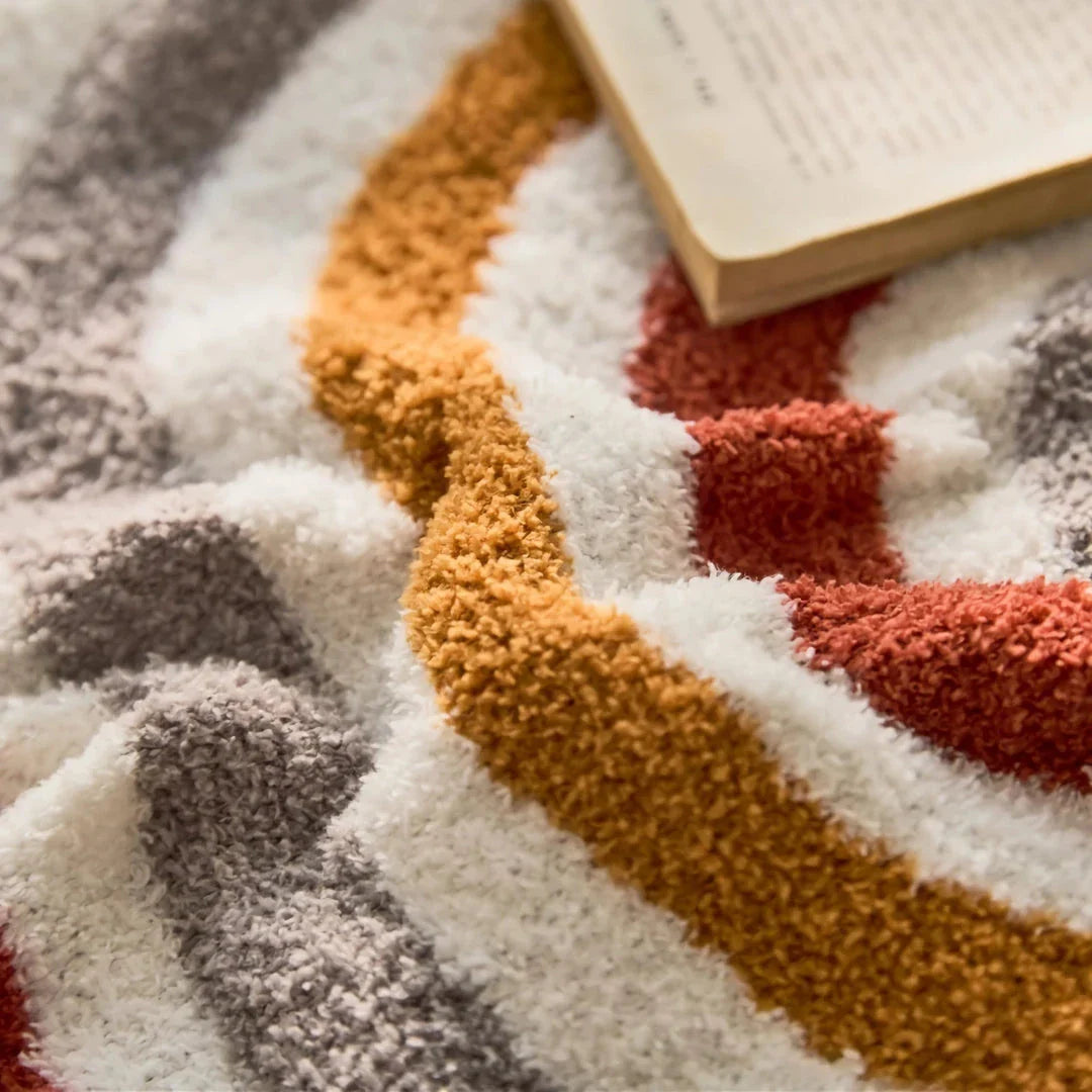 Bohemian-inspired microfibre cushion cover in light pink and white with a cosy, fuzzy texture