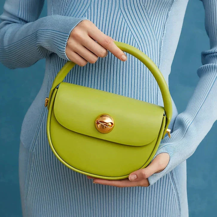 Exquisite red leather round handbag with ball-inlaid hardware, a chic and versatile accessory for UK fashion enthusiasts