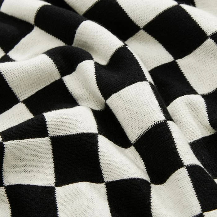Cosy checkerboard plaid cotton knitted blanket in earthy tones of green, khaki, and black for stylish home decor