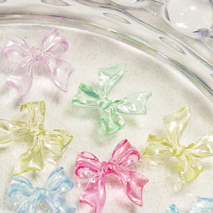 Charming candy-coloured bow nail charms in various colours, perfect for adding a playful touch to your manicure