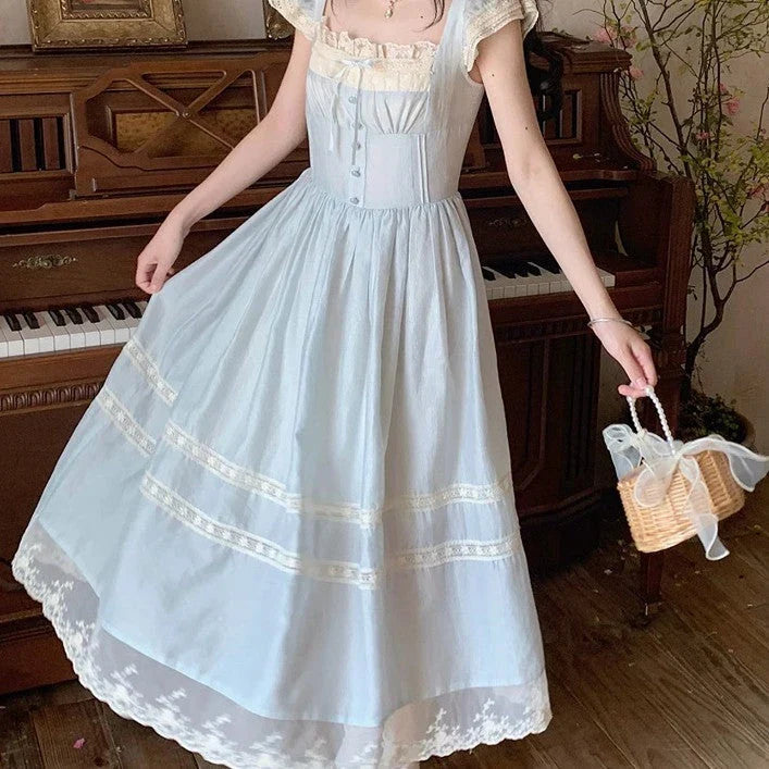Elegant lace-trimmed blue maxi dress with high-waisted silhouette and sleeveless design