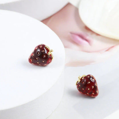 Pair of red resin strawberry stud earrings with a three-dimensional design and secure backing