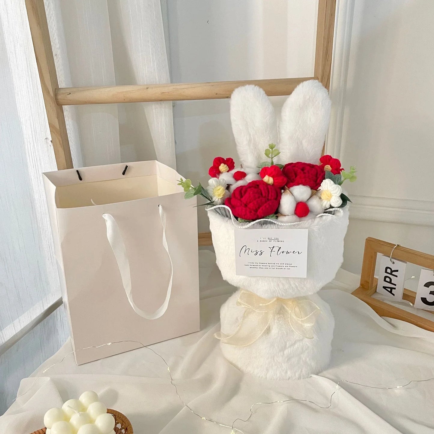 A delightful knitted rabbit bouquet doll in vibrant colours, featuring soft plush materials and a charming design