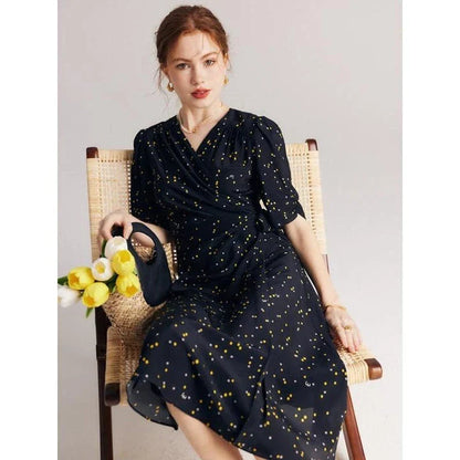 Elegant black polka dot silk wrap dress with V-neck and empire waistline, perfect for formal and casual occasions