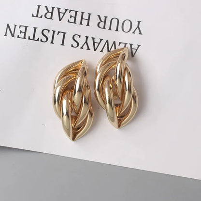 Elegant geometric statement earrings with a luxurious gold finish, featuring a unique hollow twist design.