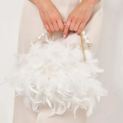 Elegant feather clutch bag with pearls and metal chains, a versatile and sophisticated evening accessory
