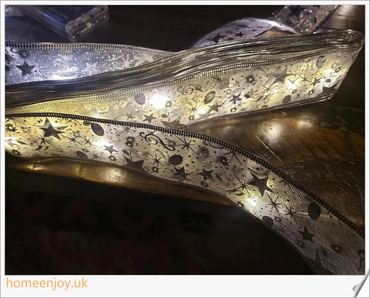 Festive Christmas ribbon fairy lights with 100 warm LED lights, available in gold and silver colours