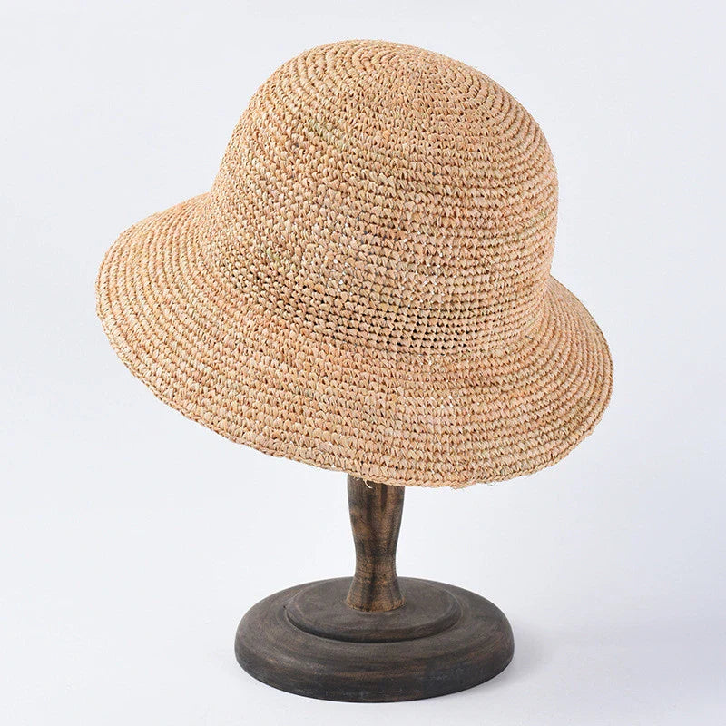 Handcrafted raffia sun hat for women, with a flat brim design and adjustable sizing for versatile sun protection and stylish summer wear