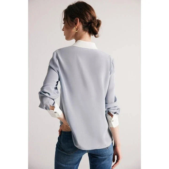 A chic and elegant silk crepe de chine blouse in a timeless solid pattern, perfect for professional and casual wear.