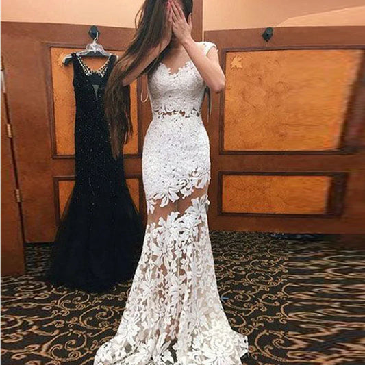 Elegant white lace cocktail dress with sleeveless design and flowing skirt