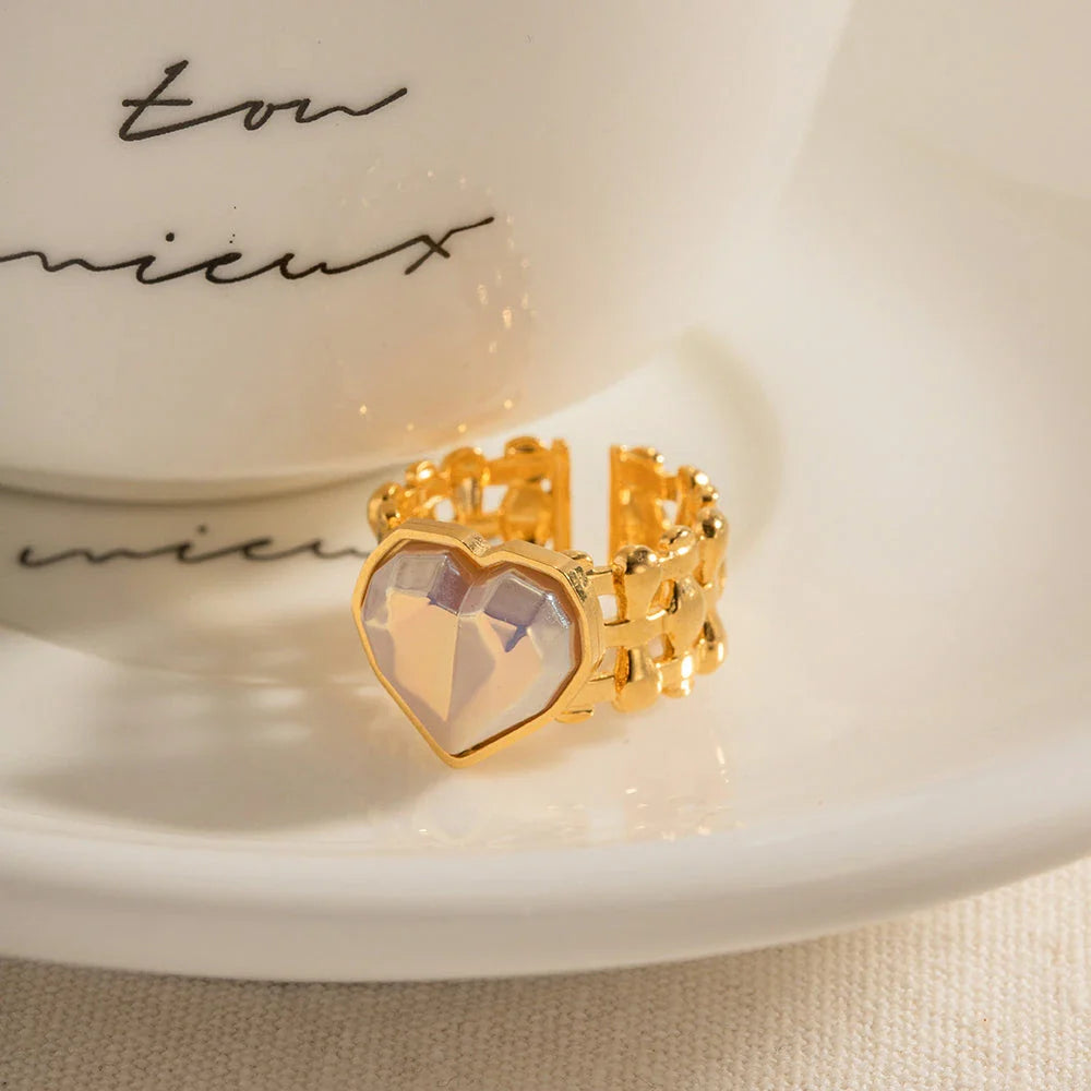 Adjustable stainless steel ring with a mermaid-inspired heart design and shell beads, a unique and versatile accessory.