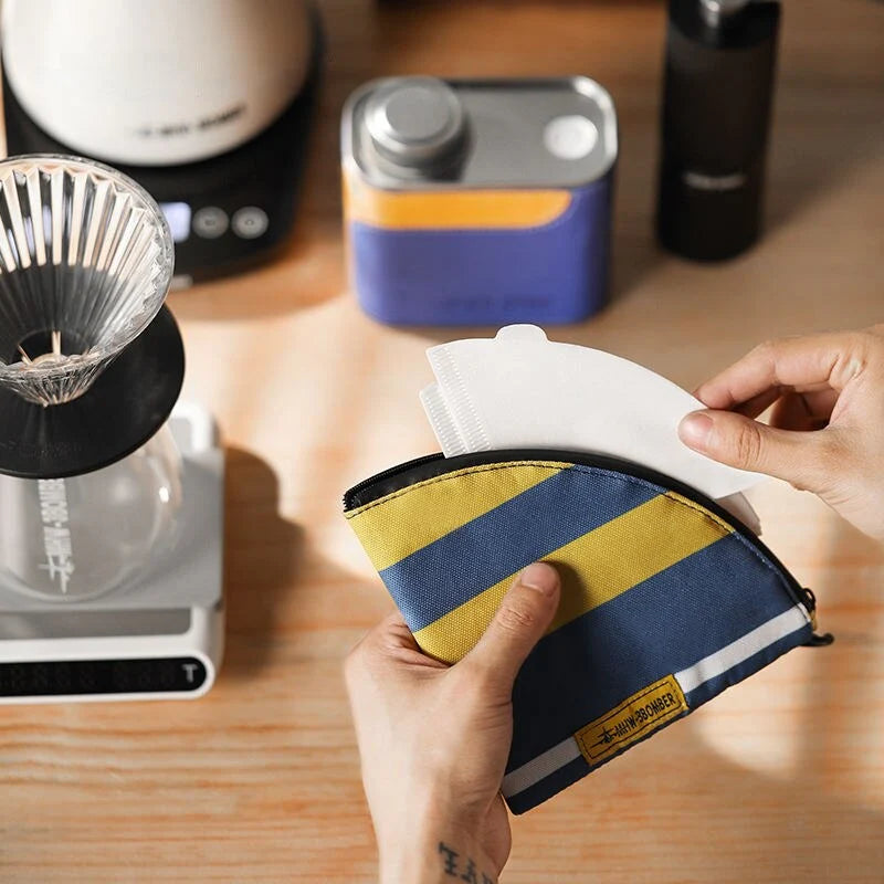 Airtight metal coffee and tea canister with portable filter paper storage, perfect for camping and home use
