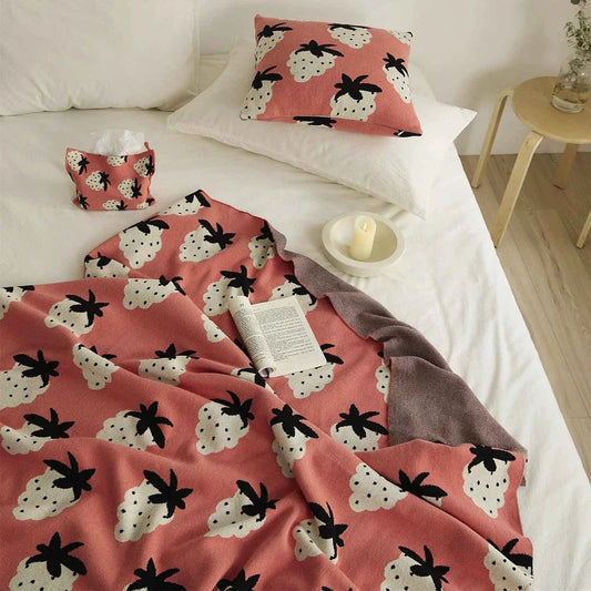 A cosy grape-patterned cotton blanket with a sophisticated design, perfect for relaxation and home decor