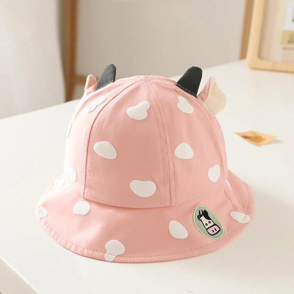Adorable cow-patterned kids' bucket hat made of soft, breathable cotton for comfortable outdoor wear