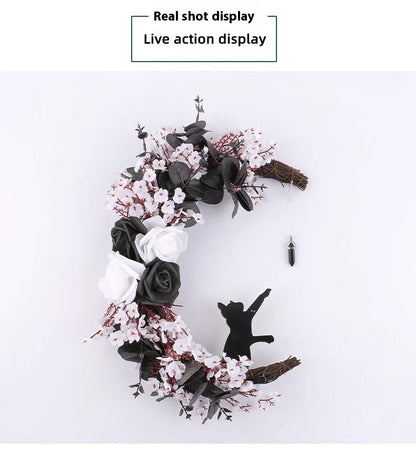 Spooktacular Halloween garland featuring a blend of dried white flowers, black roses, and mystical moon cat ornaments