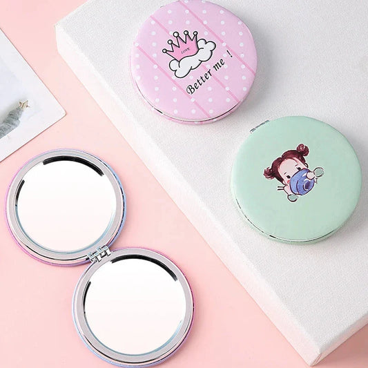 Compact portable foldable makeup mirror with cute cartoon prints for on-the-go beauty touch-ups