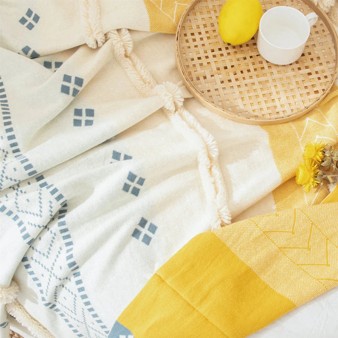 Cosy cotton tufted throw blanket with a geometric pattern and tassels in a soft yellow colour