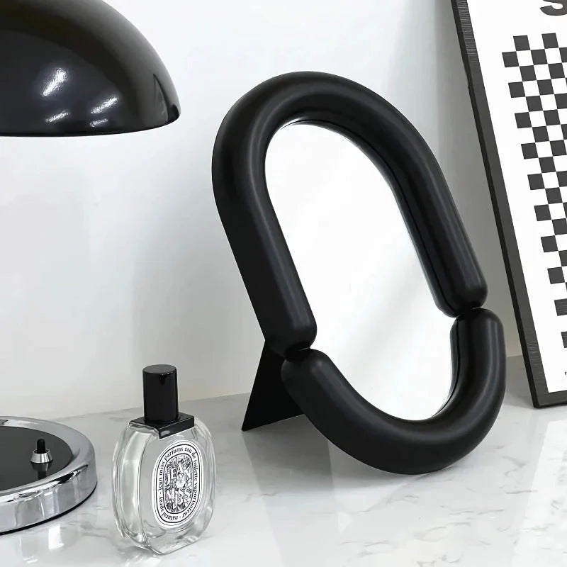 Elegant irregular oval-shaped black tabletop mirror for sophisticated home decor