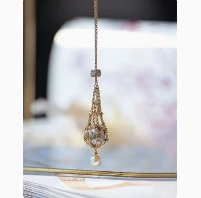 Elegant shell bead necklace with 18K gold plating and a delicate net crystal pendant