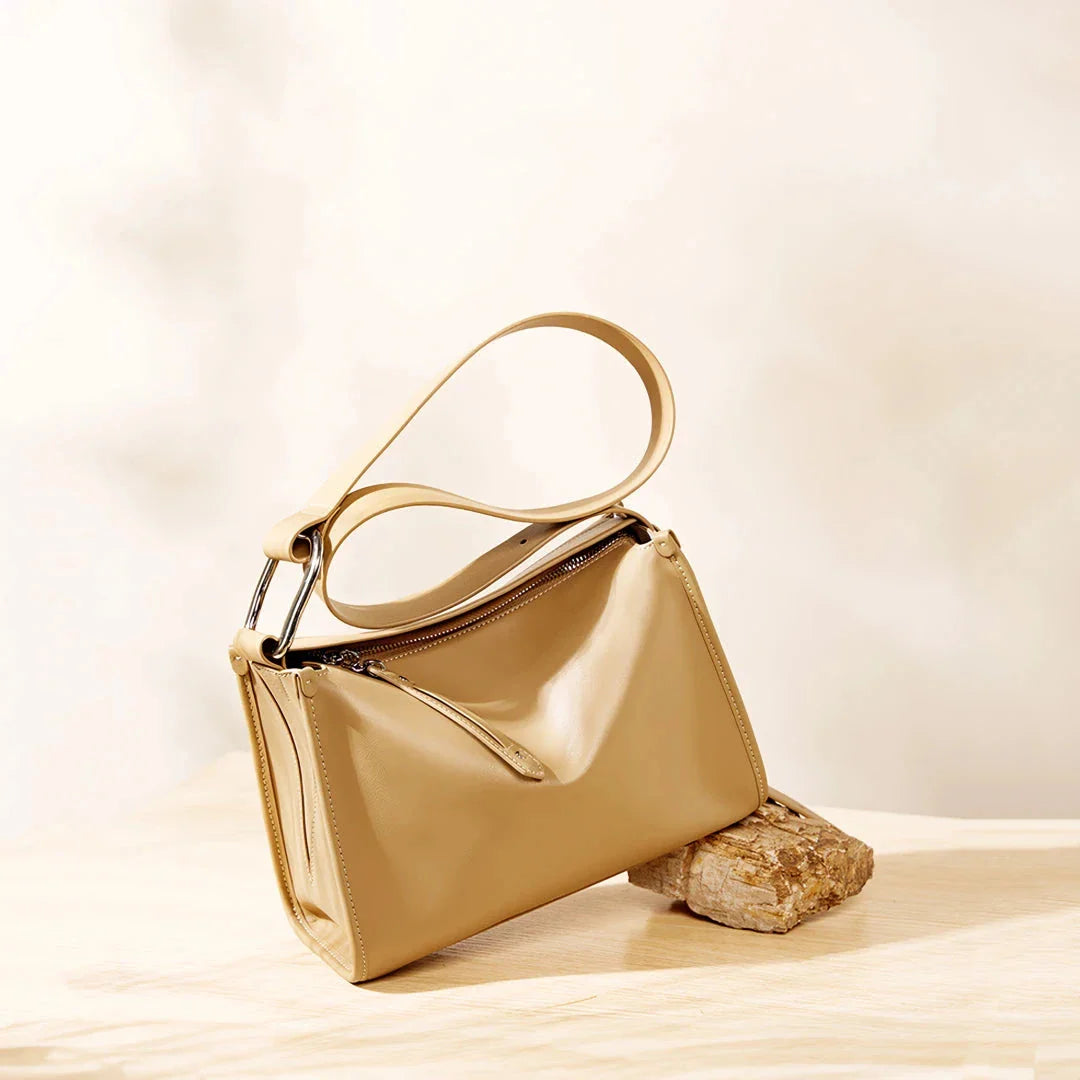 Genuine leather shoulder bag with soft, pillow-like shape and secure zipper closure