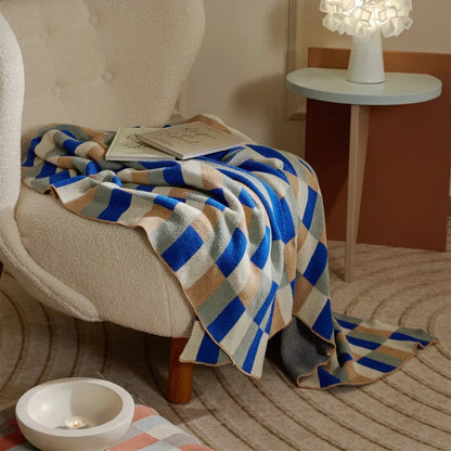 Cosy 100% cotton striped plaid throw blanket in vibrant orange and blue hues, perfect for adding rustic charm to any living space.