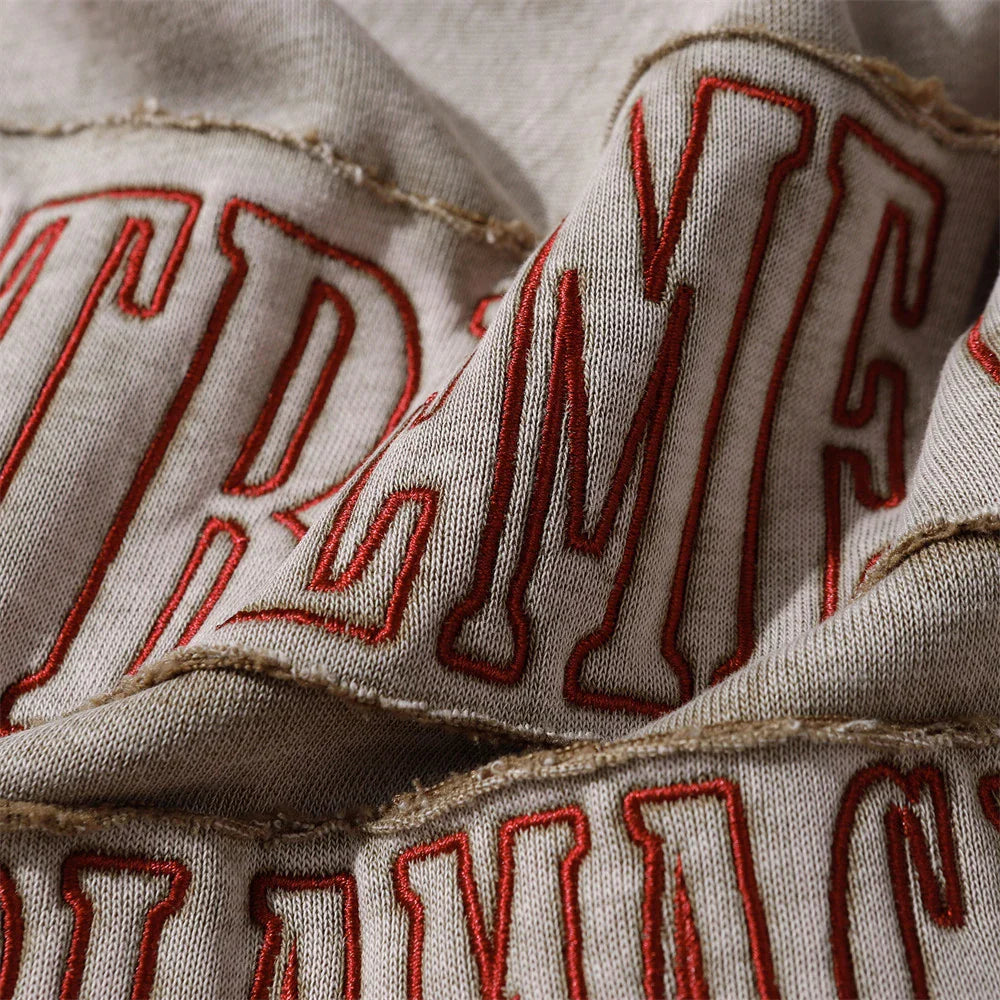 A premium cotton pullover hoodie with an embroidered letter patch in a variety of classic autumn colours
